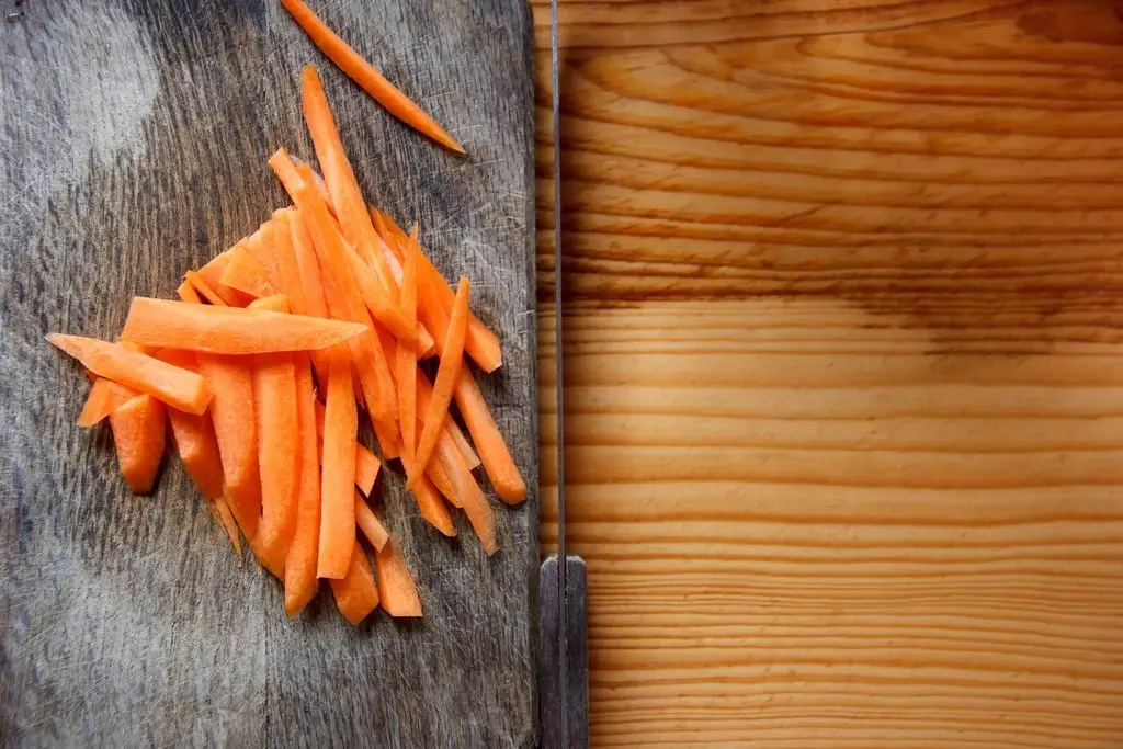 Acacia wood cutting board with fresh vegetables