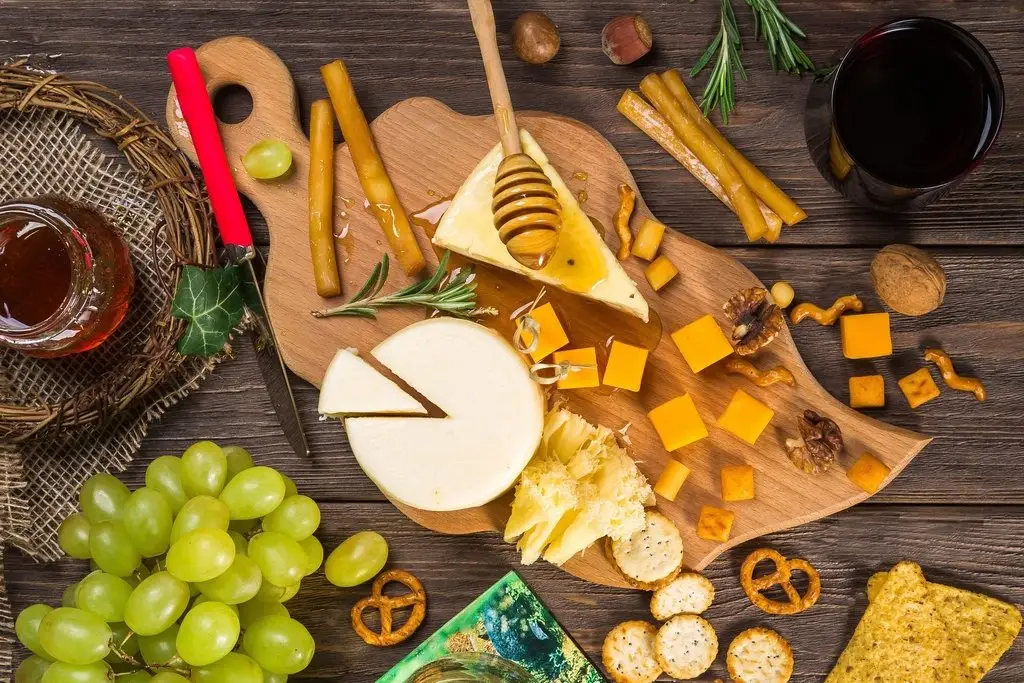 Charcuterie board with cheese and grapes