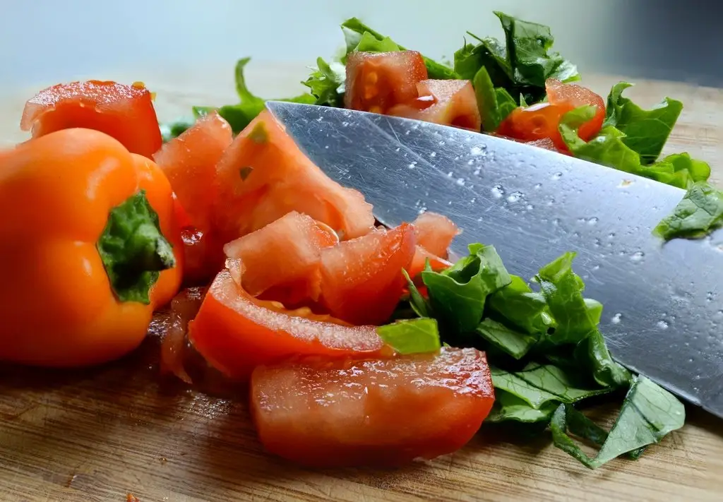 Wood cutting board with chopped vegetables