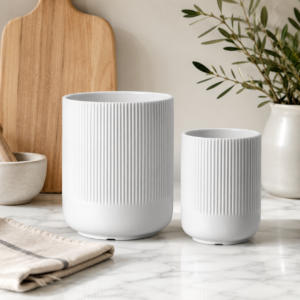 White fluted ceramic utensil holder set on kitchen countertop
