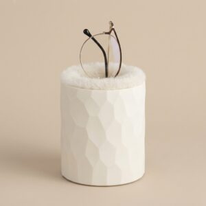 Ivory plush lined eyeglass holder standing on nightstand