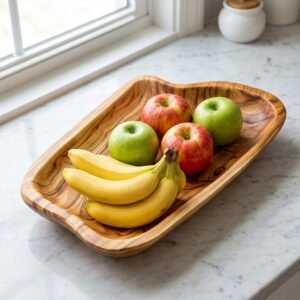 Hand carved live edge wood fruit bowl with natural grain on kitchen counter