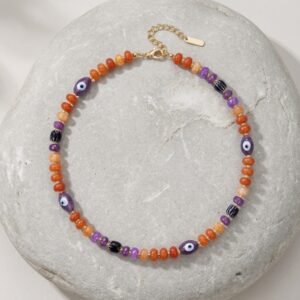 Halloween beaded necklace with evil eye and pumpkin beads on a copper chain choker